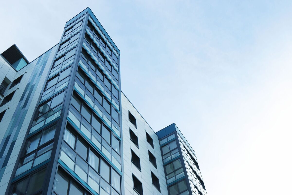 Modern mid-rise building with blue glass facade